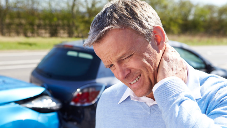 Man suffering from neck pain after car accident injury