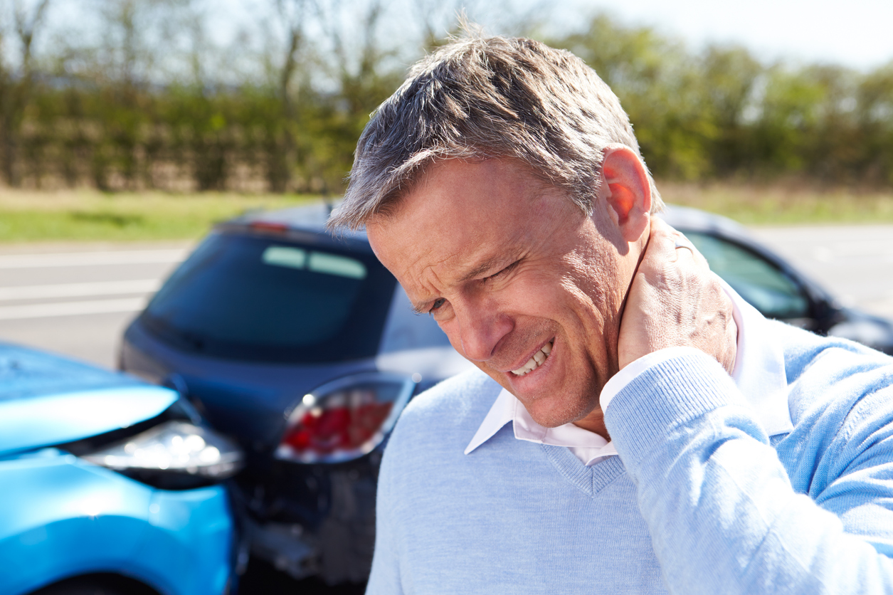 Man suffering from neck pain after car accident injury